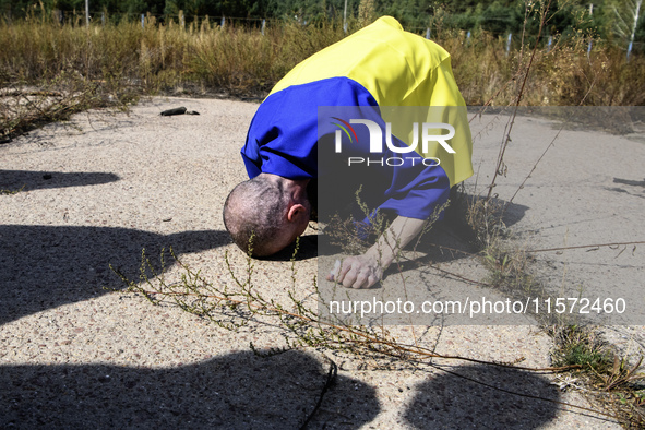 A Ukrainian prisoner of war (POW) reacts as he exits a bus as forty-nine civilian and military Ukrainians return to Ukraine from captivity i...