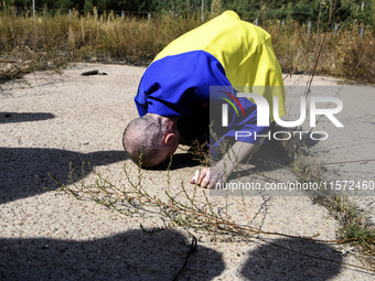 A Ukrainian prisoner of war (POW) reacts as he exits a bus as forty-nine civilian and military Ukrainians return to Ukraine from captivity i...