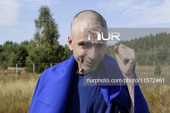 A Ukrainian prisoner of war (POW) reacts as he exits a bus as forty-nine civilian and military Ukrainians return to Ukraine from captivity i...