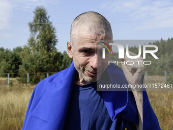 A Ukrainian prisoner of war (POW) reacts as he exits a bus as forty-nine civilian and military Ukrainians return to Ukraine from captivity i...