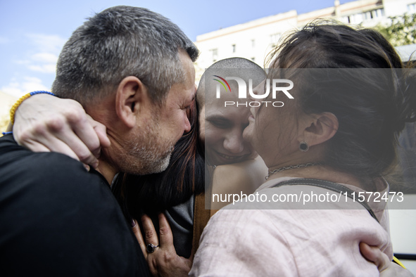 Parents hug their son who returns from captivity as forty-nine civilian and military Ukrainians return to Ukraine after a swap with Russia i...