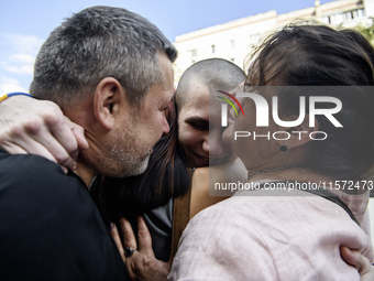 Parents hug their son who returns from captivity as forty-nine civilian and military Ukrainians return to Ukraine after a swap with Russia i...