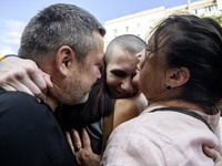 Parents hug their son who returns from captivity as forty-nine civilian and military Ukrainians return to Ukraine after a swap with Russia i...