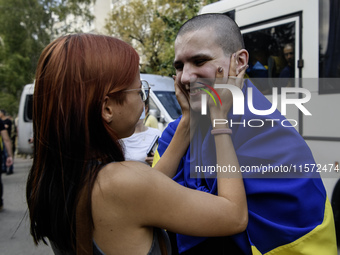 A relative hugs a Ukrainian prisoner of war (POW) who returns from captivity as forty-nine civilian and military Ukrainians return to Ukrain...