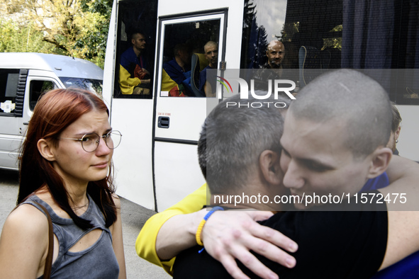 Parents hug their son who returns from captivity as forty-nine civilian and military Ukrainians return to Ukraine after a swap with Russia i...