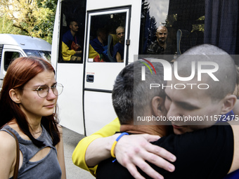 Parents hug their son who returns from captivity as forty-nine civilian and military Ukrainians return to Ukraine after a swap with Russia i...