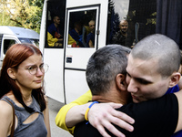 Parents hug their son who returns from captivity as forty-nine civilian and military Ukrainians return to Ukraine after a swap with Russia i...