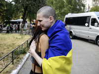 A relative hugs a Ukrainian prisoner of war (POW) who returns from captivity as forty-nine civilian and military Ukrainians return to Ukrain...