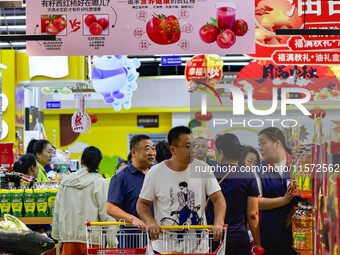 Consumers shop at a supermarket in Qingzhou, China, on September 9, 2024. On September 14, 2024, the National Bureau of Statistics releases...