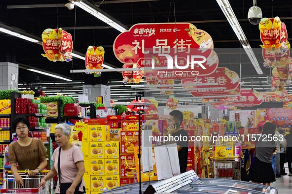 Consumers shop at a supermarket in Qingzhou, China, on September 9, 2024. On September 14, 2024, the National Bureau of Statistics releases...