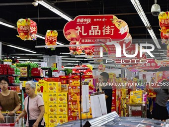 Consumers shop at a supermarket in Qingzhou, China, on September 9, 2024. On September 14, 2024, the National Bureau of Statistics releases...