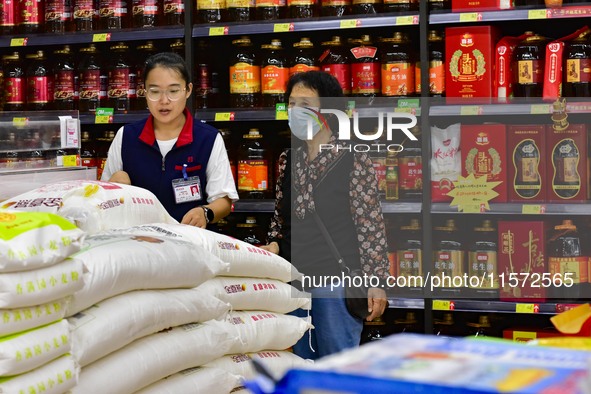 Consumers shop at a supermarket in Qingzhou, China, on September 9, 2024. On September 14, 2024, the National Bureau of Statistics releases...