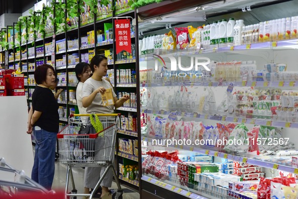 Consumers shop at a supermarket in Qingzhou, China, on September 9, 2024. On September 14, 2024, the National Bureau of Statistics releases...