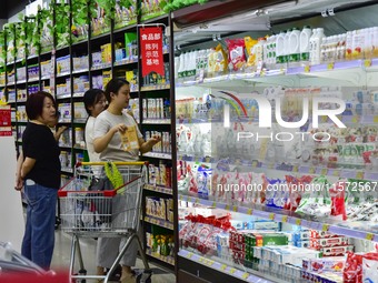 Consumers shop at a supermarket in Qingzhou, China, on September 9, 2024. On September 14, 2024, the National Bureau of Statistics releases...