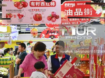 Consumers shop at a supermarket in Qingzhou, China, on September 9, 2024. On September 14, 2024, the National Bureau of Statistics releases...