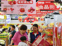 Consumers shop at a supermarket in Qingzhou, China, on September 9, 2024. On September 14, 2024, the National Bureau of Statistics releases...