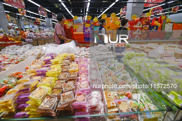 Consumers shop at a supermarket in Qingzhou, China, on September 9, 2024. On September 14, 2024, the National Bureau of Statistics releases...