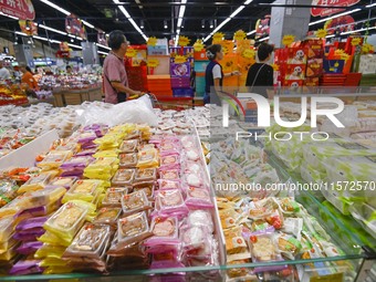 Consumers shop at a supermarket in Qingzhou, China, on September 9, 2024. On September 14, 2024, the National Bureau of Statistics releases...