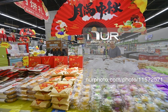 Consumers shop at a supermarket in Qingzhou, China, on September 9, 2024. On September 14, 2024, the National Bureau of Statistics releases...