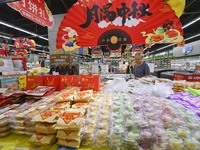 Consumers shop at a supermarket in Qingzhou, China, on September 9, 2024. On September 14, 2024, the National Bureau of Statistics releases...