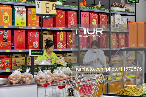 Consumers shop at a supermarket in Qingzhou, China, on September 9, 2024. On September 14, 2024, the National Bureau of Statistics releases...