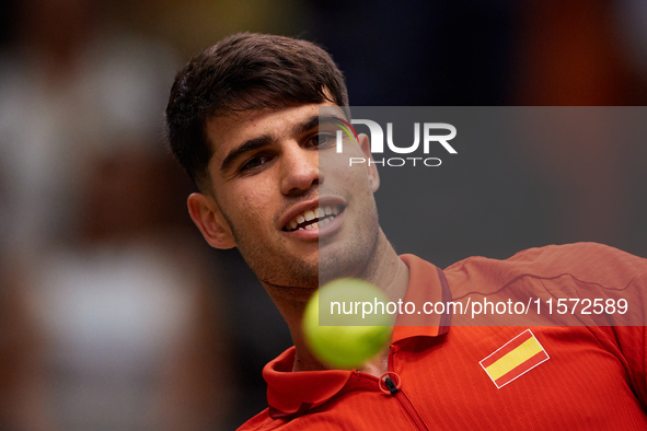 Carlos Alcaraz of Spain looks at the ball following the game against Ugo Humbert of France during the 2024 Davis Cup Group B Stage match bet...