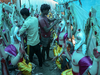 Artists prepare an idol of Nepali God Vishwakarma, the lord of metallurgy and god of architecture, at a workshop in Lalitpur, Nepal, on Sept...