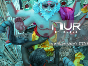 Artists prepare an idol of Nepali God Vishwakarma, the lord of metallurgy and god of architecture, at a workshop in Lalitpur, Nepal, on Sept...