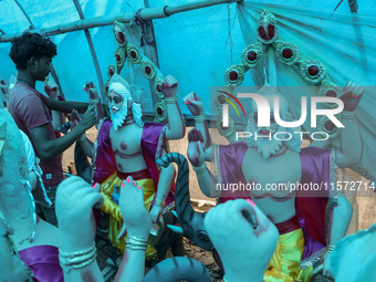 Artists prepare an idol of Nepali God Vishwakarma, the lord of metallurgy and god of architecture, at a workshop in Lalitpur, Nepal, on Sept...