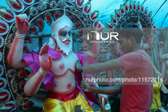 Artists prepare an idol of Nepali God Vishwakarma, the lord of metallurgy and god of architecture, at a workshop in Lalitpur, Nepal, on Sept...