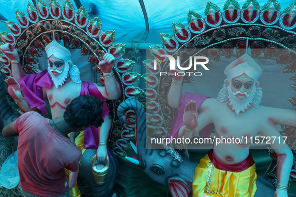 Artists prepare an idol of Nepali God Vishwakarma, the lord of metallurgy and god of architecture, at a workshop in Lalitpur, Nepal, on Sept...