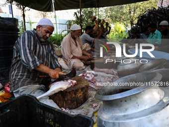 Traditional Kashmiri chefs cut lamb meat to prepare wazwan dishes in Sopore, Jammu and Kashmir, India, on September 14, 2024. Wazwan is a tr...