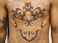 A person poses for a photo showing his tattooed body, which features Hindu Lord Bhairav, during the Himalayan Tattoo Convention in Lalitpur,...