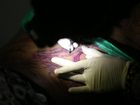 An artist inks a tattoo on the body of an enthusiast during the Himalayan Tattoo Convention in Lalitpur, Nepal, on August 14, 2024. The tatt...