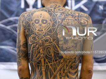 A person poses for a photo showing his tattooed body during the Himalayan Tattoo Convention in Lalitpur, Nepal, on August 14, 2024. The tatt...