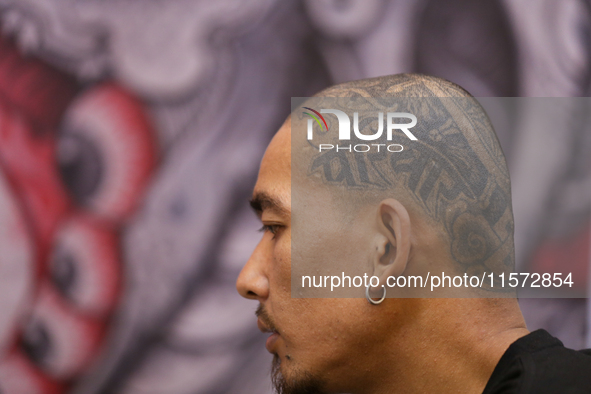 A person with the word ''Pariwar'' or family inked on the left side of his head is pictured during the Himalayan Tattoo Convention in Lalitp...