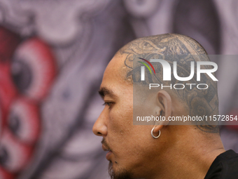 A person with the word ''Pariwar'' or family inked on the left side of his head is pictured during the Himalayan Tattoo Convention in Lalitp...