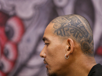 A person with the word ''Pariwar'' or family inked on the left side of his head is pictured during the Himalayan Tattoo Convention in Lalitp...