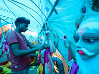 An artist decorates the idol of Hindu lord Bishwokarma, the main craftsman and architect of gods, at a workshop in Lalitpur, Nepal, on Septe...