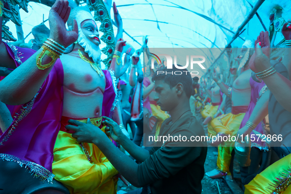 An artist decorates the idol of Hindu lord Bishwokarma, the main craftsman and architect of gods, at a workshop in Lalitpur, Nepal, on Septe...