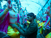 An artist decorates the idol of Hindu lord Bishwokarma, the main craftsman and architect of gods, at a workshop in Lalitpur, Nepal, on Septe...