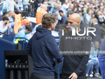 Manchester City F.C. manager Pep Guardiola and Brentford manager shake hands during the Premier League match between Manchester City and Bre...