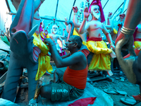 An artist decorates the idol of Hindu lord Bishwokarma, the main craftsman and architect of gods, at a workshop in Lalitpur, Nepal, on Septe...