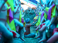 An artist decorates the idol of Hindu lord Bishwokarma, the main craftsman and architect of gods, at a workshop in Lalitpur, Nepal, on Septe...