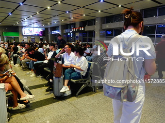 A large number of passengers prepare to travel at Yichang East Railway Station during the Mid-Autumn Festival holiday in Yichang, China, on...