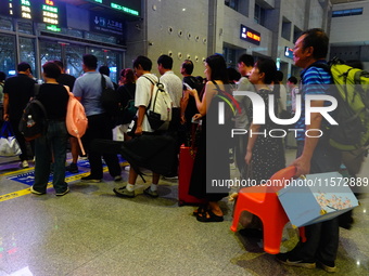 A large number of passengers prepare to travel at Yichang East Railway Station during the Mid-Autumn Festival holiday in Yichang, China, on...