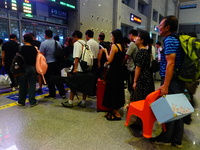 A large number of passengers prepare to travel at Yichang East Railway Station during the Mid-Autumn Festival holiday in Yichang, China, on...