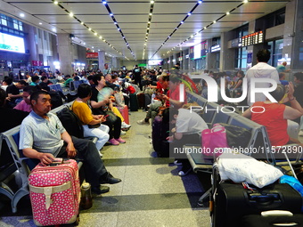 A large number of passengers prepare to travel at Yichang East Railway Station during the Mid-Autumn Festival holiday in Yichang, China, on...