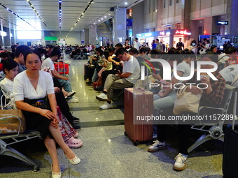 A large number of passengers prepare to travel at Yichang East Railway Station during the Mid-Autumn Festival holiday in Yichang, China, on...