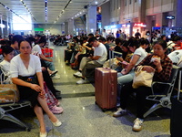 A large number of passengers prepare to travel at Yichang East Railway Station during the Mid-Autumn Festival holiday in Yichang, China, on...